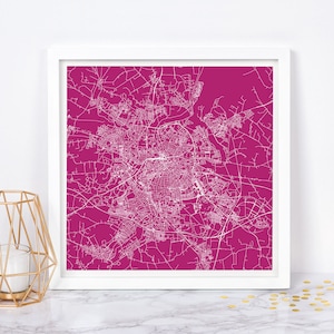 May include: A white line art map of a city printed on a magenta background. The map is framed in a white frame.