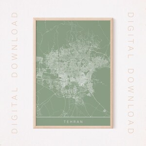 May include: A printable map of Tehran, Iran, in a sage green color with white lines showing the city streets. The map is framed in a light wood frame. The text "TEHRAN" is printed in white at the bottom of the map.