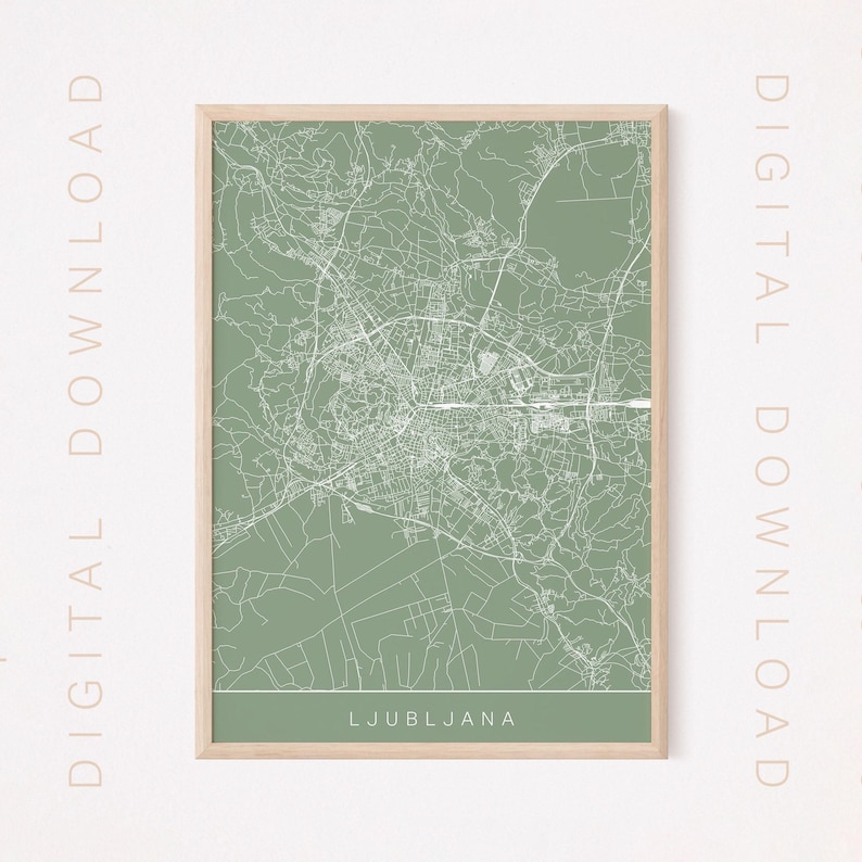 May include: A framed map print of Ljubljana, Slovenia, in a minimalist style. The map features white lines on a muted green background, with the city name at the bottom. The frame is a light wood color, and the words "DIGITAL DOWNLOAD" are printed vertically on the sides.