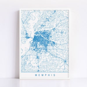 May include: A framed print featuring a detailed blue map of Memphis, Tennessee, against a white background. The city's road network is intricately displayed. The word "MEMPHIS" is printed in blue at the bottom of the frame.