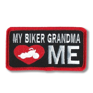 May include: Embroidered patch with the text "MY BIKER GRANDMA ME". The patch features a red heart with a white motorcycle graphic. The patch has a black background and a red border.