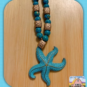 May include: A white ceramic mug with a black handle and the text "But First, Coffee" in a bold, black font. The mug is set against a neutral background, highlighting its simple design.