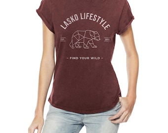 May include: A maroon t-shirt with a white graphic of a geometric bear and the text "Lasko Lifestyle Est. 2015 - Find Your Wild - "