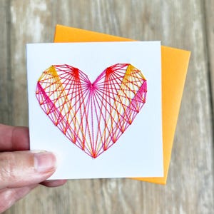 STRING HEART CARD / hand-stitched pink, orange, & gold heart on white
