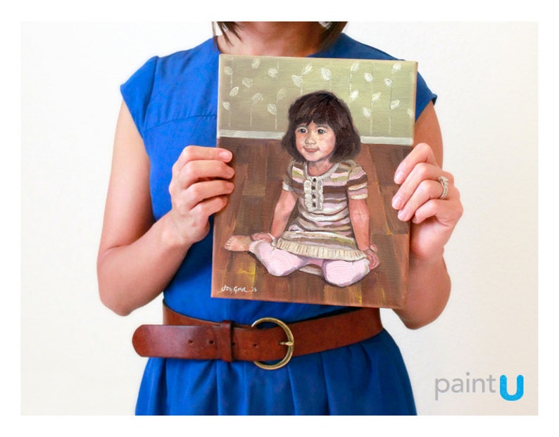 May include: A painting of a young girl sitting on a wooden floor. She is wearing a striped shirt and a pink skirt. The painting has a light brown background with a pattern of white leaves.
