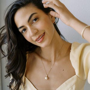 Model wearing Polly Star Locket Necklace with star charm, showcasing effortless style and elegance.