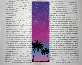 May include: A bookmark with a gradient background of pink and blue with white stars. Two palm trees are silhouetted against the sky. The bookmark has the text "The World's Most Willing Whipping Boy" at the top.
