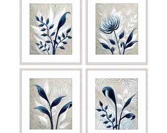 May include: Set of four framed prints featuring blue and white stylized floral illustrations on a beige background.