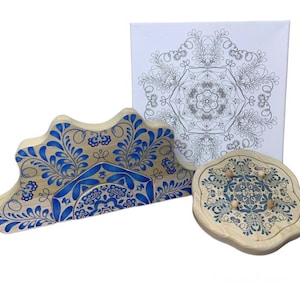 May include: A set of three wooden mandala-shaped puzzle pieces with blue and white floral designs. The pieces are designed to fit together to create a larger mandala.