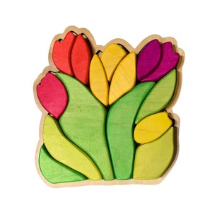 May include: Wooden puzzle of a bouquet of tulips with red, yellow, and purple flowers and green leaves.