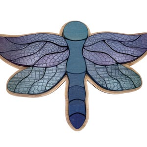 May include: A wooden dragonfly wall art piece with blue and purple stained glass wings.