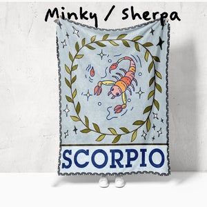 May include: A blue and green minky/sherpa throw blanket with a scorpion illustration and the word "SCORPIO" in a blue banner.