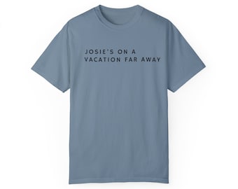 May include: A light blue t-shirt with the text "JOSIE'S ON A VACATION FAR AWAY" printed in black.