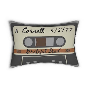 May include: A grey and beige throw pillow with a vintage cassette tape design. The tape is labeled "A Cornell 5/8/77 Grateful Dead 60".