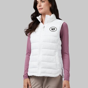 May include: White puffer vest with a zipper closure and a black oval patch with the letters "WP" on the left side of the chest.