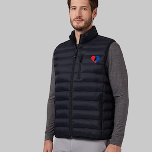 May include: A black puffer vest with a zipper closure and a small red, white, and blue heart-shaped patch on the left chest.