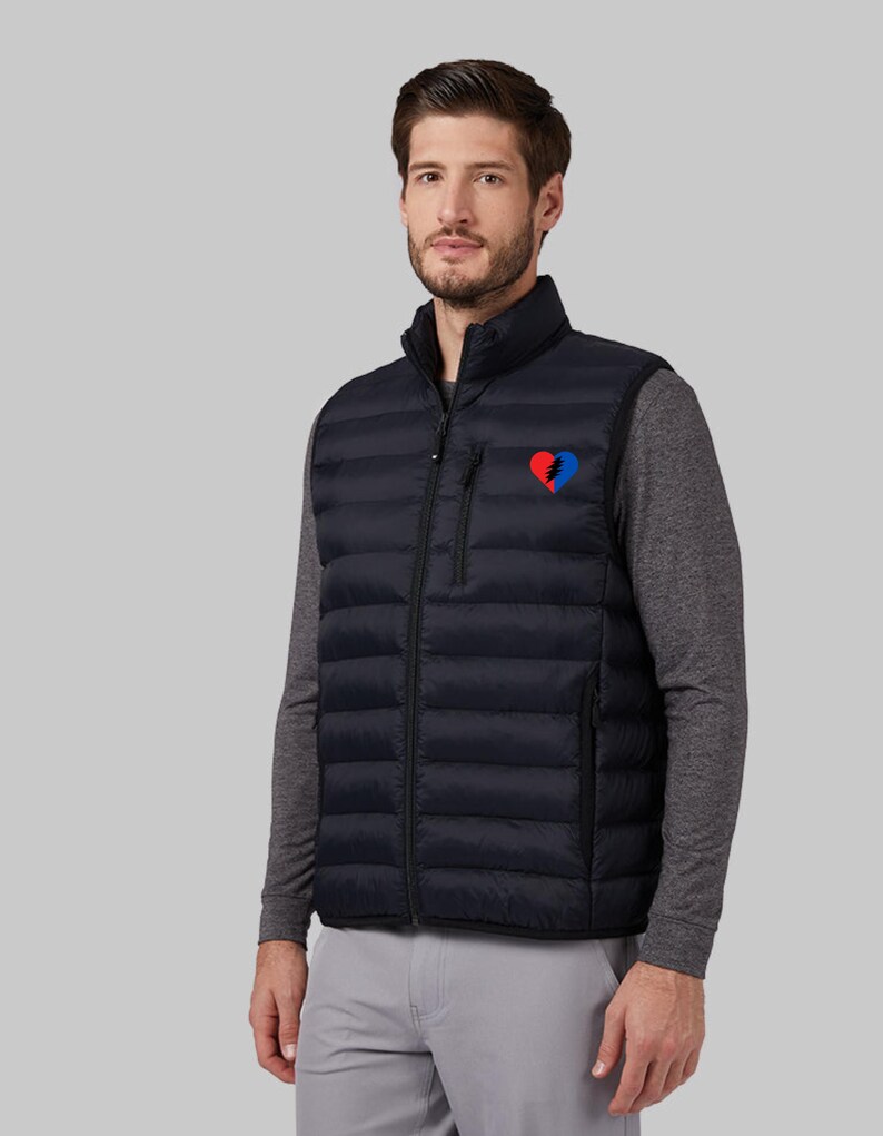 May include: A black puffer vest with a zipper closure and a small red, white, and blue heart-shaped patch on the left chest.