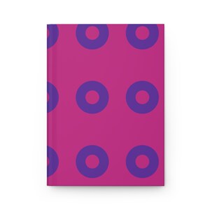 May include: A pink notebook with a repeating pattern of purple circles.
