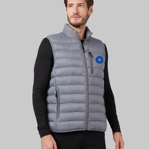 May include: A gray puffer vest with a zipper closure and a blue circle logo on the left chest.