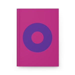 May include: A pink notebook with a purple circle containing a smaller pink circle in the center.