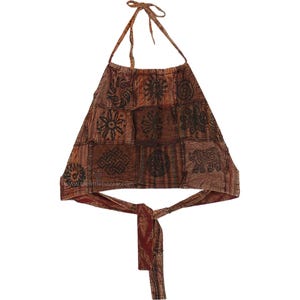 May include: Brown halter top with a patchwork design. The top features various geometric and floral patterns in dark brown and black. The halter straps and waist tie are a darker shade of brown.