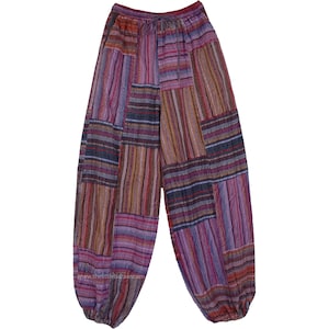 May include: Multicoloured striped trousers with a patchwork design. The trousers have a wide leg and a gathered elastic waistband.