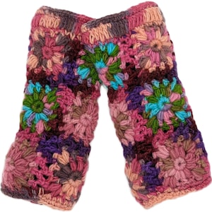 May include: A pair of colorful, crocheted arm warmers. The arm warmers feature a floral pattern in shades of pink, purple, green, and blue. The crochet work is detailed and the overall design is handmade.