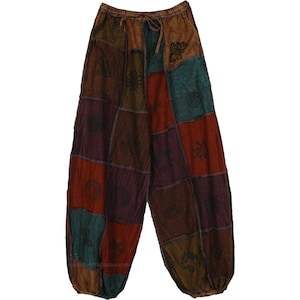 May include: Patchwork pants in shades of brown, red, green, and purple. The pants have a drawstring waist and a relaxed fit. Each panel features a unique embroidered design, creating a bohemian style.