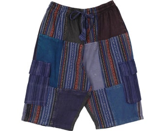 May include: Patchwork shorts in shades of blue, gray, and burgundy. The shorts feature a drawstring waist and multiple fabric panels with striped and geometric patterns. Two cargo pockets are visible on the front.