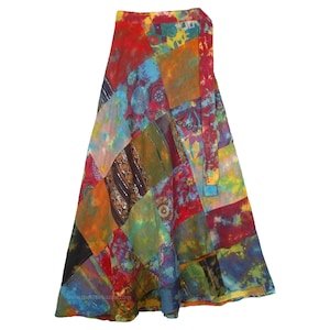 May include: A colorful patchwork wrap skirt with a tie closure. The skirt is made of various fabrics in shades of red, orange, yellow, green, blue, and purple. The skirt is a long, flowing style.