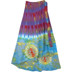 May include: A colorful tie-dye wrap skirt in shades of blue, purple, red, and yellow. The skirt features a layered design with a vibrant, swirling pattern. The fabric appears to be lightweight, suitable for warm weather.