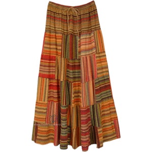May include: A long, multi-coloured patchwork skirt with a brown, orange, red and green striped pattern. The skirt has a drawstring waist.
