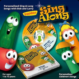 May include: A VeggieTales Sing-Along personalized children's music set featuring a CD case, a disc, and characters including a green cucumber, red tomato, orange carrot, and green asparagus. Text includes Personalized Sing-A-Long Songs with Bob and Larry.