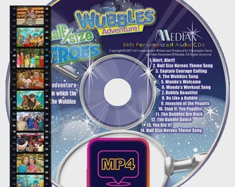 May include: A CD with the title "The Wubbles Adventure!" and the text "Half Size Heroes". The CD has a blue and purple design with a list of songs. A small MP4 download icon is in the lower right corner.