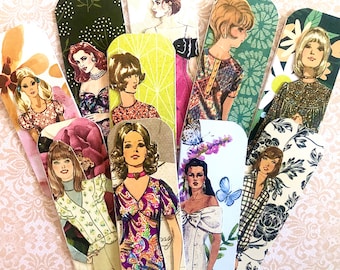 May include: A set of ten colorful bookmarks featuring vintage illustrations of women in various styles and poses. The bookmarks are printed on cardstock and have a glossy finish.