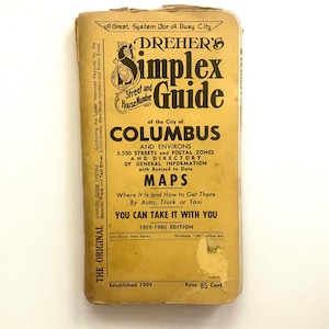 May include: A vintage 1959-1960 edition of Dreher's Simplex Street and House Number Guide of the City of Columbus and Environs. The rectangular book cover is tan with black text, featuring the title, map information, and a price of 85 cents.