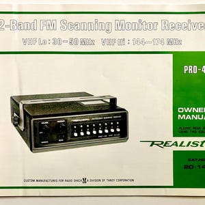 May include: A vintage Realistic PRO-45 2-Band FM Scanning Monitor Receiver owner's manual. The manual is white with green accents and features the product's image. The receiver is black with silver details and has several buttons and dials. The text includes "2-Band FM Scanning Monitor Receiver".