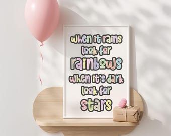 May include: A framed print with the text "When it rains look for rainbows, when it's dark look for stars." A pink balloon floats above a wooden shelf holding the framed print and a small gift box.