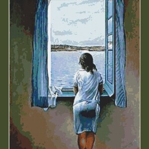 May include: A woman in a white dress stands by a window looking out at a body of water. The window is open and the curtains are blue. The water is blue and the sky is cloudy.