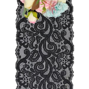 May include: Black lace trim with a delicate floral pattern. The lace is soft and flexible, making it ideal for adding a touch of elegance to any project.