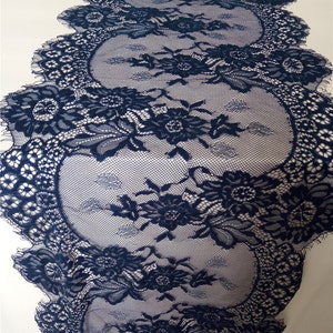 May include: Navy blue lace trim with a scalloped edge and floral pattern.