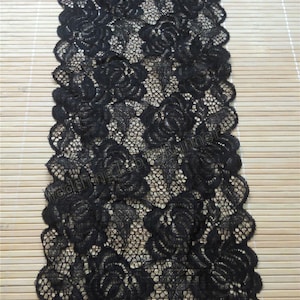 May include: Black lace trim with a floral pattern. The lace is delicate and has a scalloped edge.