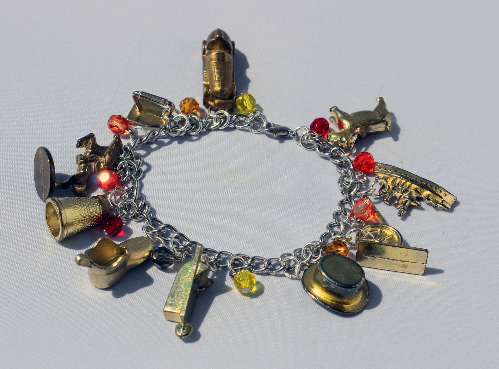 Gold Monopoly Token Charm Bracelet With Fiery Glass Beads Etsy