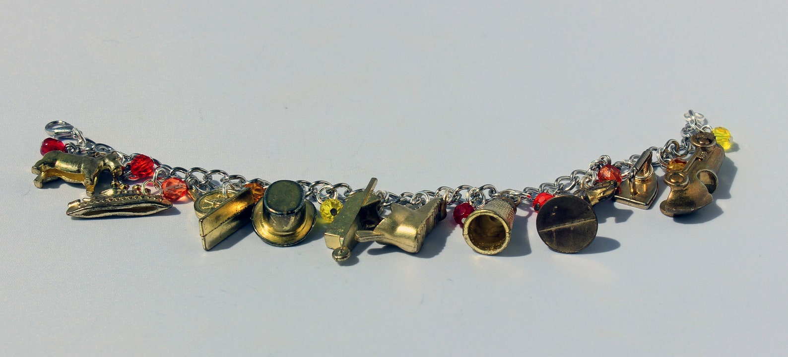 Gold Monopoly Token Charm Bracelet With Fiery Glass Beads Etsy