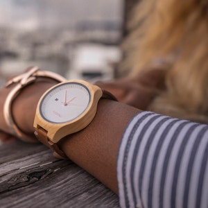 Women's watch on a wrist with yellow color