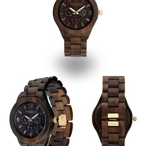 May include: A collection of wooden watches in various angles. The watches are made of dark brown wood with gold-colored accents. The watch face displays the brand name "modply". The watch bands are also made of wood.