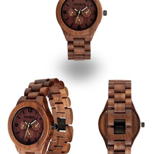 May include: Wooden wristwatch with a dark brown face and matching wooden band. The watch face features the brand name "modply" and three smaller dials. The watch is displayed from multiple angles, showcasing its wooden construction and design.