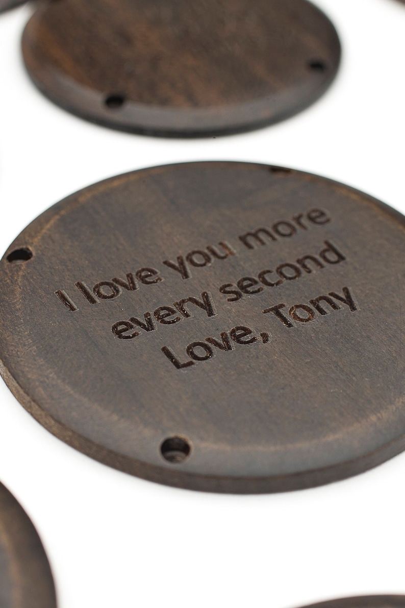 以下が含まれることがあります： 「I love you more every second Love, Tony」という文字が刻まれた、濃い茶色の木製の円形です。