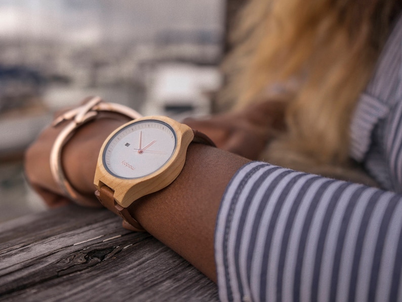 Women's watch on a wrist with yellow color