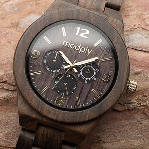 Wooden watch for men on a raw wooden background